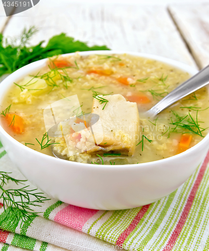 Image of Soup fish with millet and spoon on white board