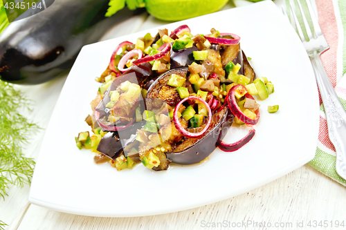 Image of Salad from eggplant and cucumber in plate on board