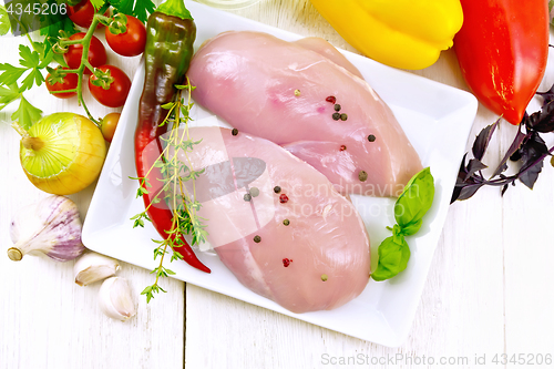 Image of Chicken breast raw in plate on light board top