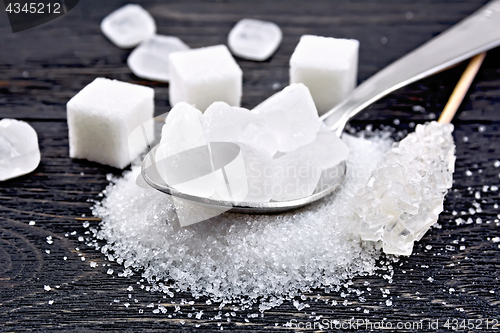 Image of Sugar white crystalline in spoon on board