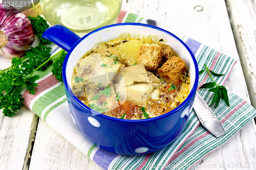 Image of Soup fish with vegetables and croutons on light board