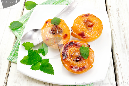 Image of Quince baked with mint in plate on board