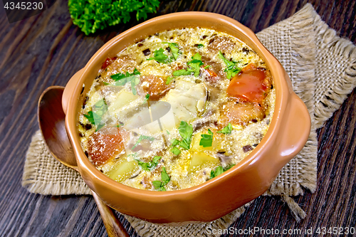 Image of Soup fish with vegetables and herbs on dark board