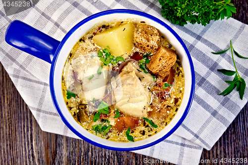 Image of Soup fish with vegetables and croutons on board top