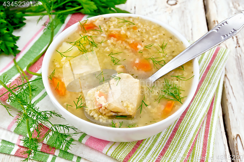 Image of Soup fish with millet and spoon on light board