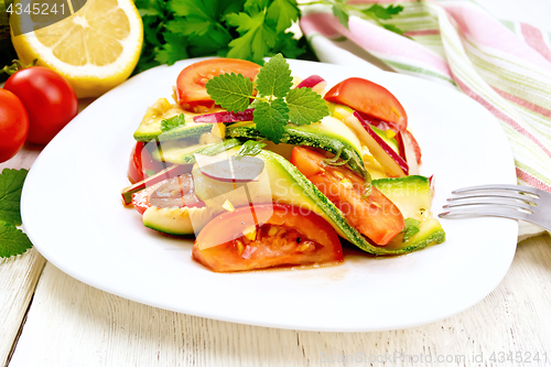 Image of Salad with zucchini and tomato on light board