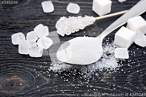 Image of Sugar white in spoon on black board