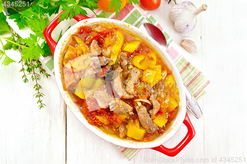 Image of Ragout of meat and vegetables in brazier on board top