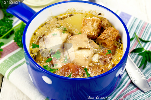 Image of Soup fish with vegetables and herbs on light board