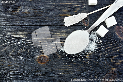 Image of Sugar white in spoon on black board top