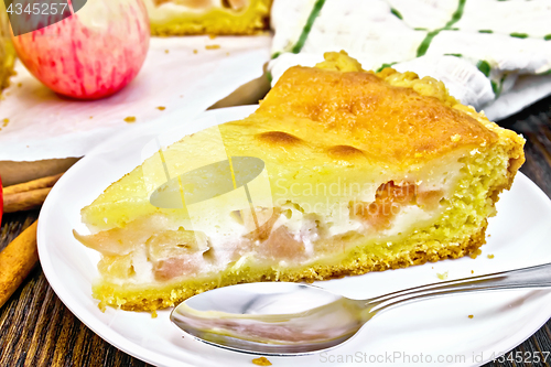 Image of Pie apple with sour cream in plate on dark board