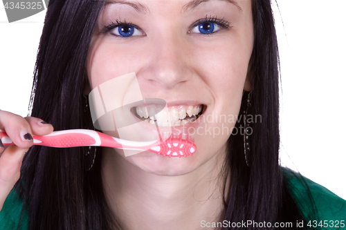 Image of Close up of a beautiful woman brushing her teeth 