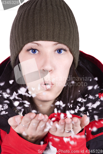 Image of Woman blowing soft white flakes