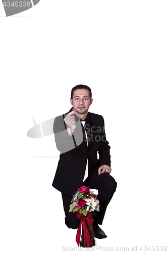 Image of Businessman with Flowers and a Ring Proposing