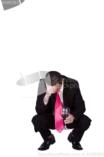 Image of Crouched Mediterranean Man Drinking