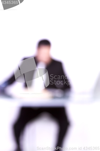 Image of Blurry Background of a Businessman at His Desk Working