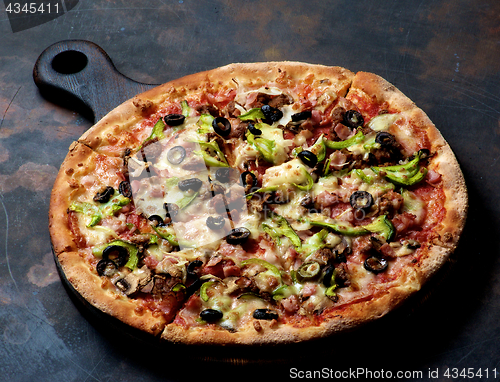 Image of Delicious Pizza with Ham, Olives and Jalapenos