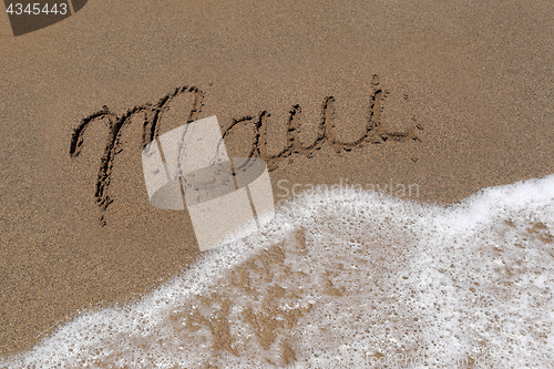 Image of Word Maui Written Into the Sand With Sea Foam