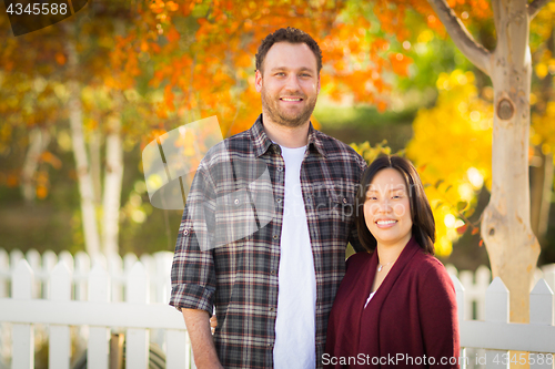 Image of Outdoor Fall Portrait of Chinese and Caucasian Young Adult Coupl