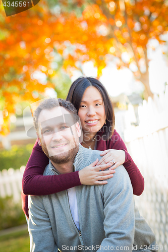 Image of Outdoor Fall Portrait of Chinese and Caucasian Young Adult Coupl