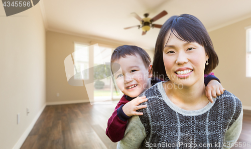 Image of Chinese Mother and Mixed Race Child Inside Empty Room Of New Hou