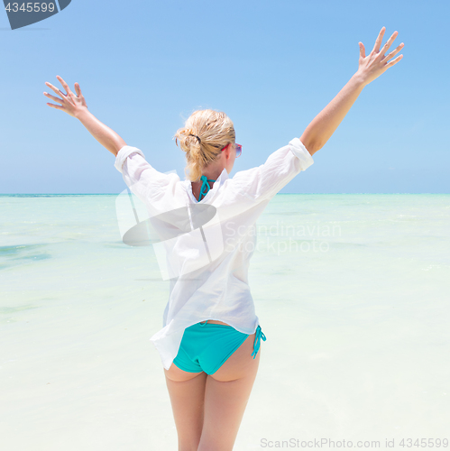 Image of Happy woman enjoying, relaxing joyfully in summer on tropical beach.