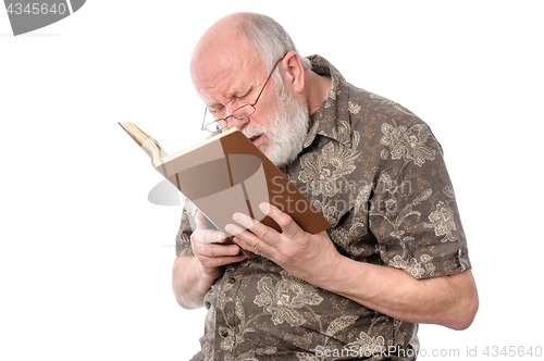 Image of Senior man with glasses reading a book
