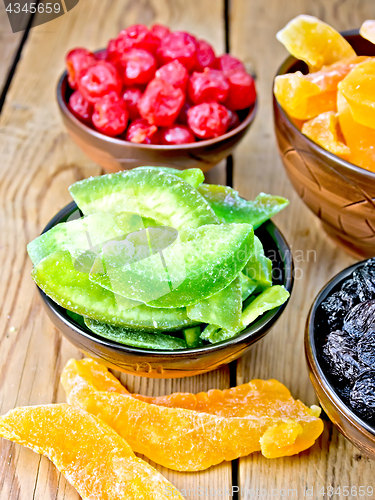 Image of Candied pomelo and berries in bowl on wooden board