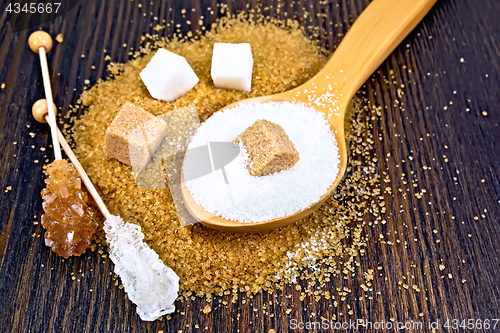 Image of Sugar white and brown different on wooden board