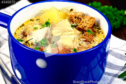 Image of Soup fish with vegetables and croutons on napkin