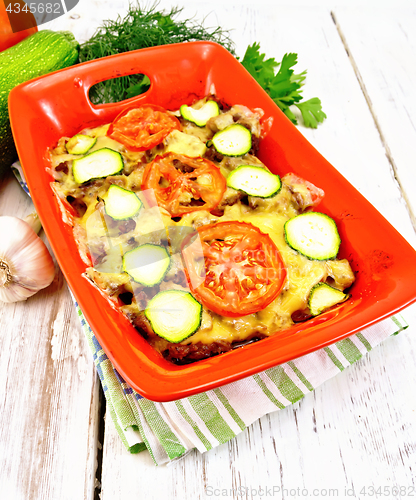 Image of Casserole from minced meat and zucchini in brazier on light boar