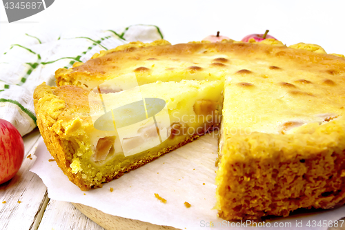 Image of Pie apple with sour cream on parchment and board