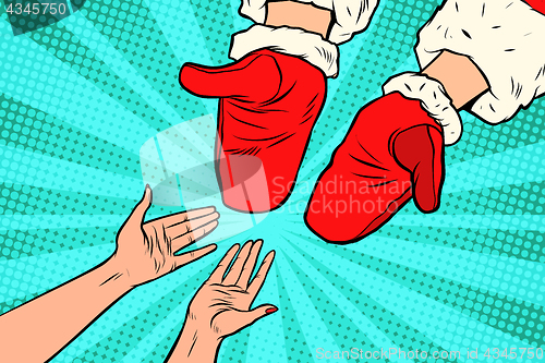 Image of Hand of Santa Claus and women