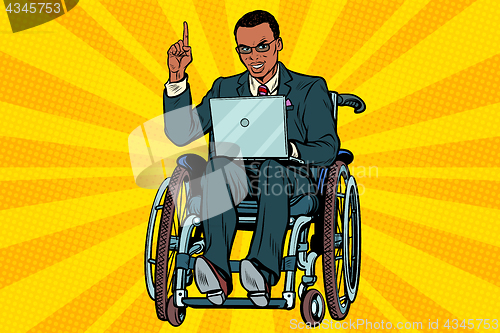 Image of African businessman in wheelchair with laptop