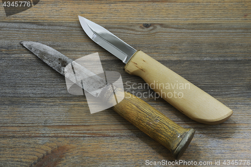 Image of two Finnish traditional knives puukko on a wooden background