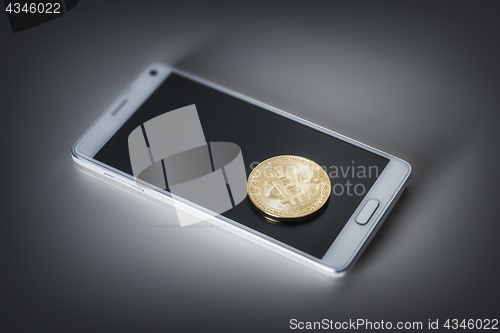 Image of mobile phone and a bitcoin