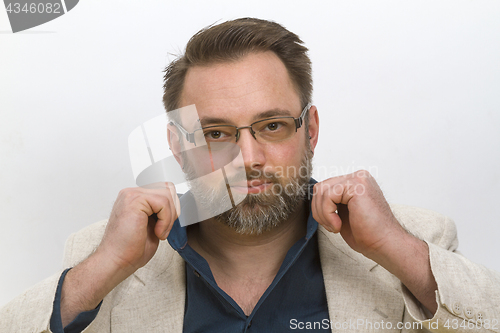 Image of Young man arranges his shirt