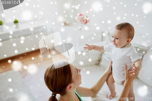 Image of happy young mother with little baby at home