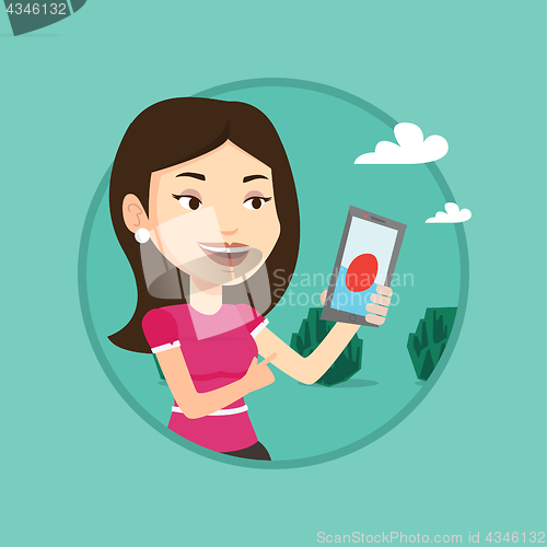 Image of Woman playing action game on smartphone.
