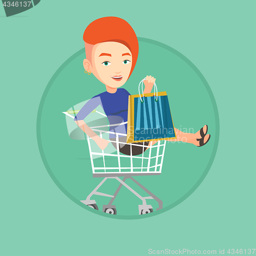 Image of Happy woman riding by shopping trolley.