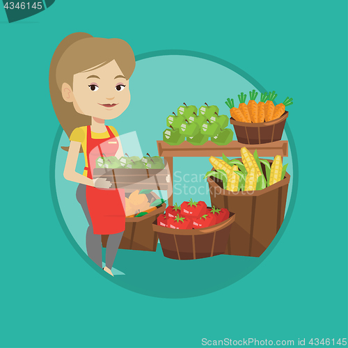 Image of Supermarket worker with box full of apples.