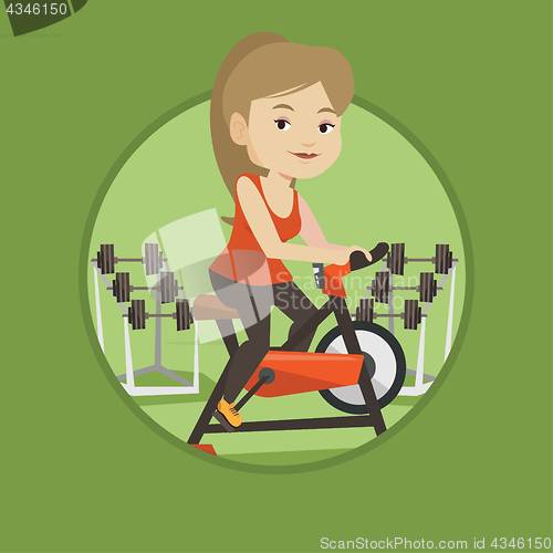 Image of Young woman riding stationary bicycle.