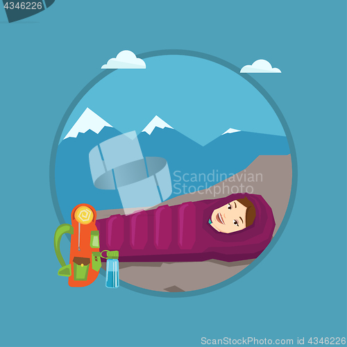 Image of Woman resting in sleeping bag in the mountains.