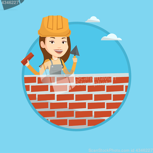 Image of Bricklayer working with spatula and brick.