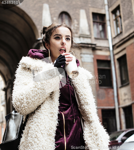 Image of young pretty stylish teenage girl outside on city street fancy f