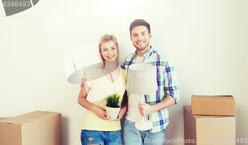 Image of happy couple with stuff moving to new home