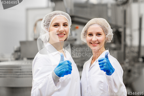 Image of happy women technologists at ice cream factory