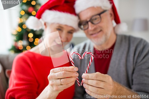 Image of senior couple with heart of christmas candy canes