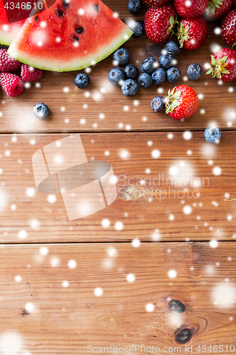 Image of close up of fruits and berries on wooden table