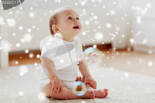 Image of happy baby with soap bubbles at home